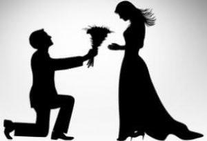 silhoutete of man giving flowers to a woman